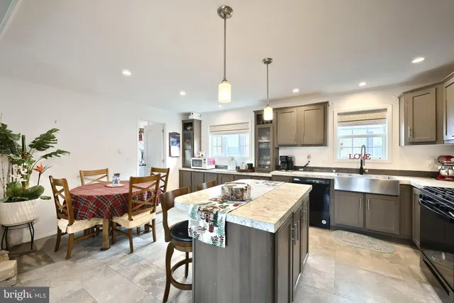 a kitchen with a table chairs sink and cabinets