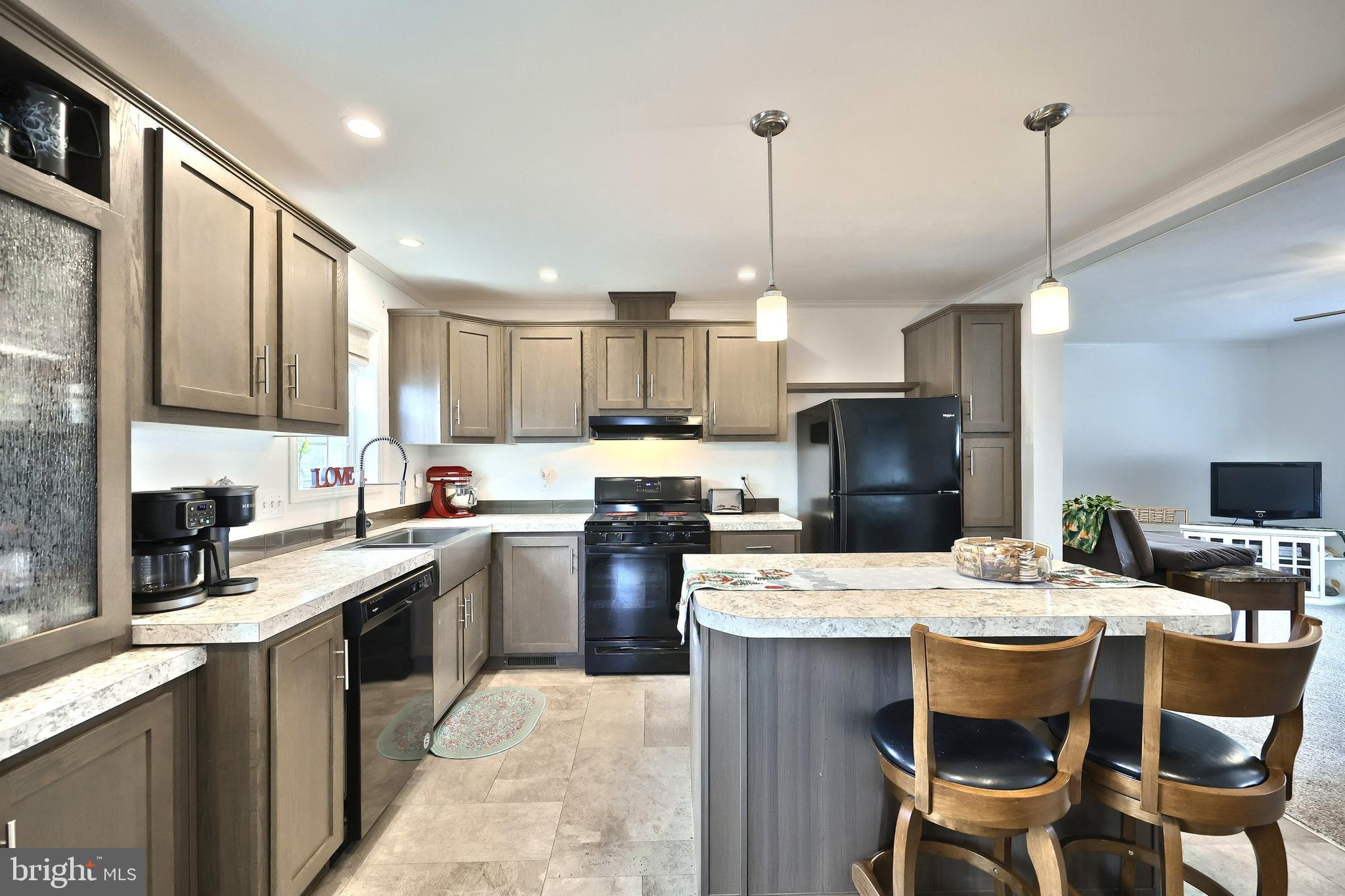 233 Eagle Drive Hanover, PA 17331 - Photo 14 of 26 a kitchen with a table chairs refrigerator and microwave