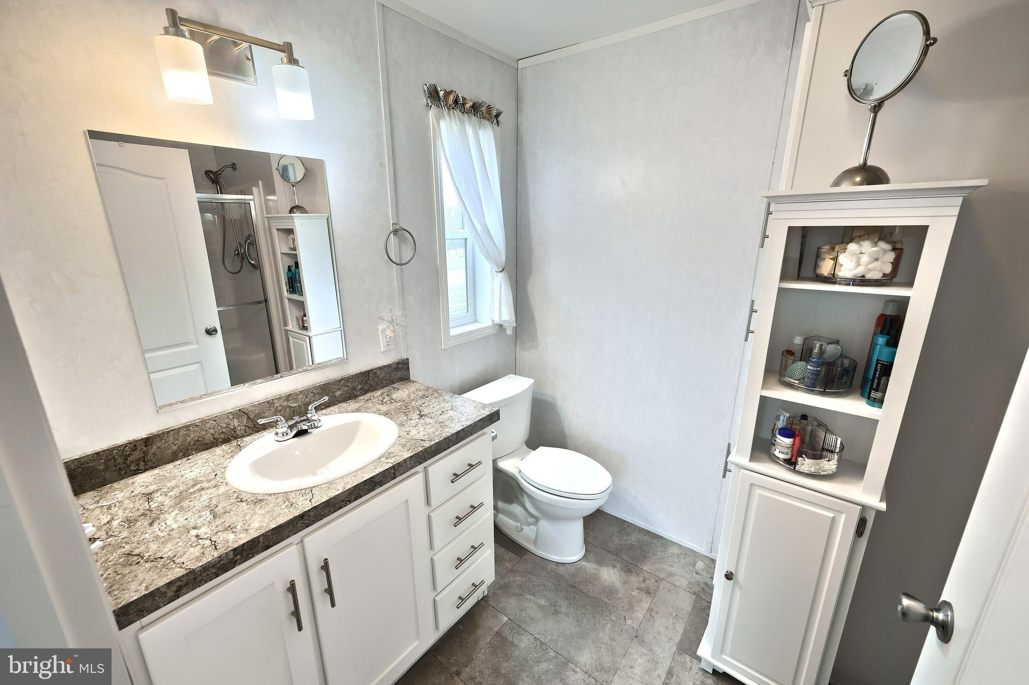 233 Eagle Drive Hanover, PA 17331 - Photo 20 of 26 a bathroom with a granite countertop sink mirror vanity and toilet