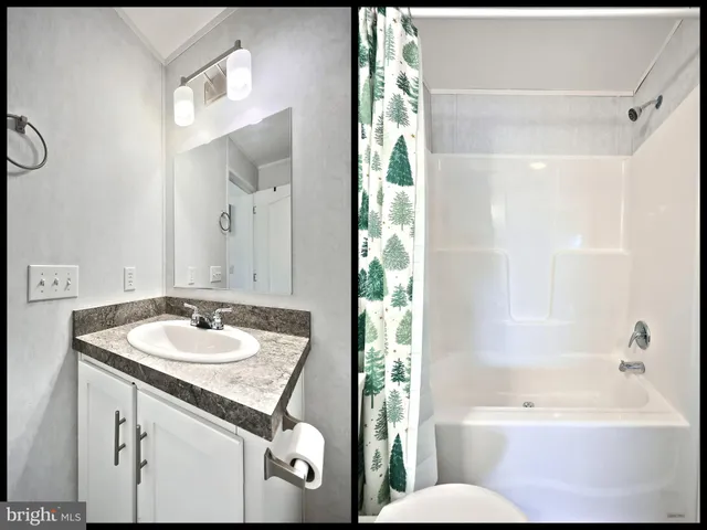 a bathroom with a sink and mirror with bathtub
