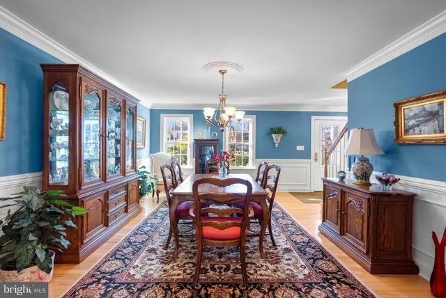 a view of a dining room with furniture large windows and wooden floor