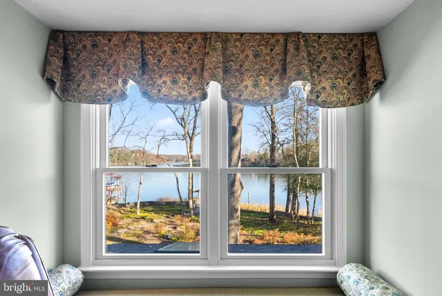 a view of a livingroom with furniture window and wooden floor