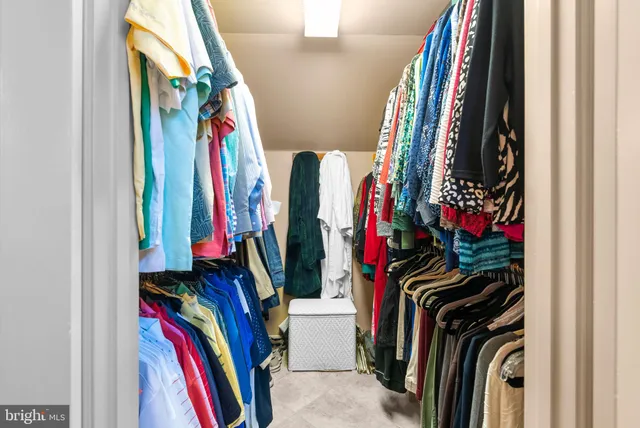 a bathroom with a glass shower door and a table