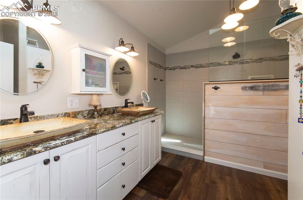 15015 Raton Road Colorado Springs, CO 80921 - Photo 23 of 45 a bathroom with a granite countertop sink mirror and double