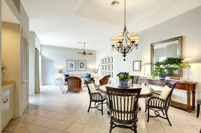 a view of a dining room with furniture a chandelier and wooden floor