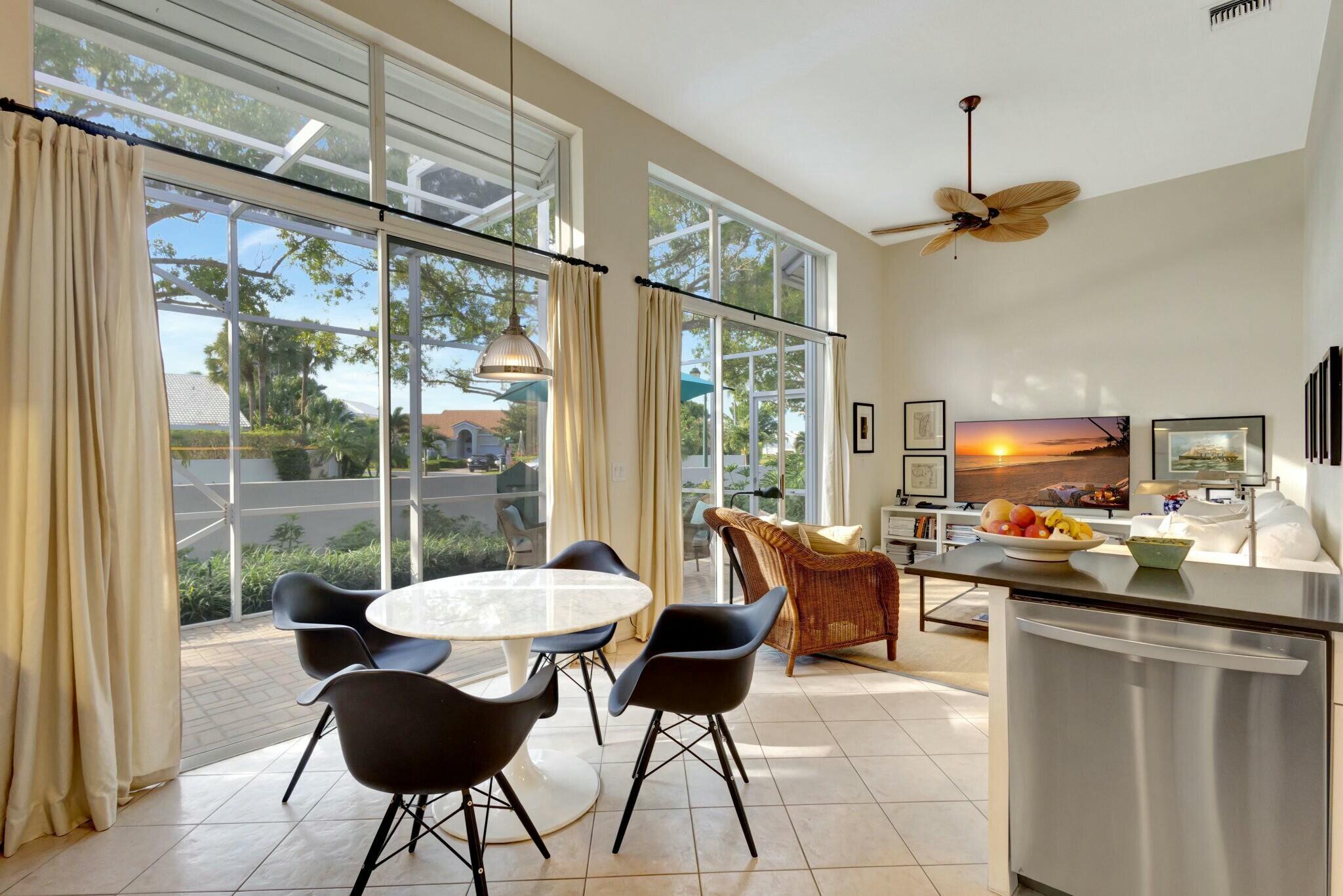 17161 Bermuda Village Drive Boca Raton, FL 33487 - Photo 18 of 54 a kitchen with a table chairs and wooden floor