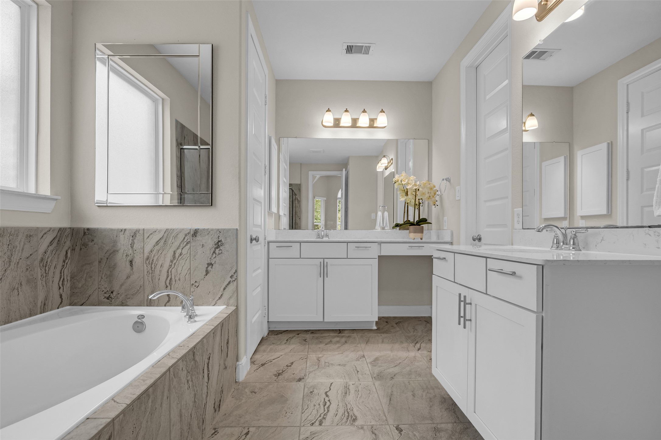 22419 Sawmill Ranch Drive Spring, TX 77389 - Photo 19 of 45 Luxurious primary en-sure with sophisticated tile, dual vanities, and walk-in closet.