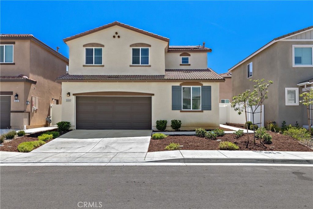 36390 West Flare Winchester, CA 92569 - Photo 2 of 46 a front view of a house with a yard and garage