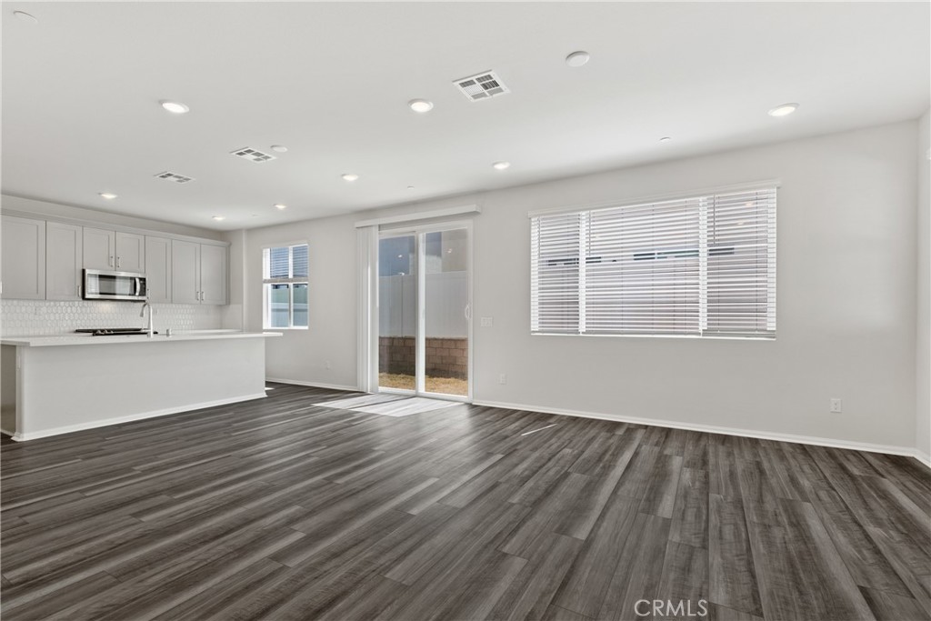 36390 West Flare Winchester, CA 92569 - Photo 32 of 46 a view of an empty room with wooden floor and a window