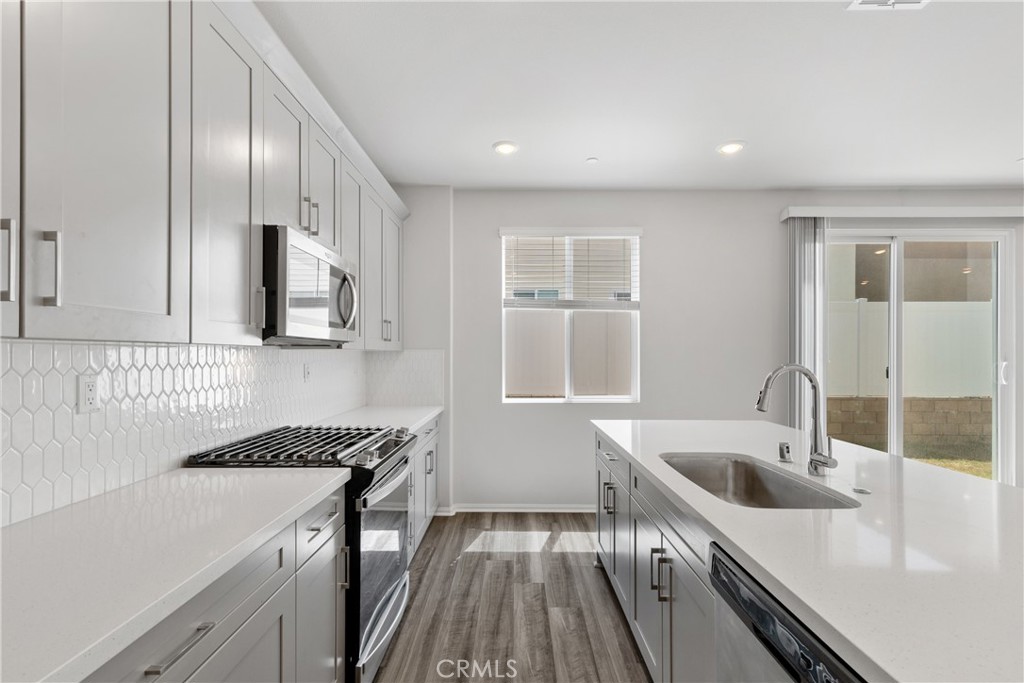 36390 West Flare Winchester, CA 92569 - Photo 37 of 46 a kitchen that has a sink and a stove