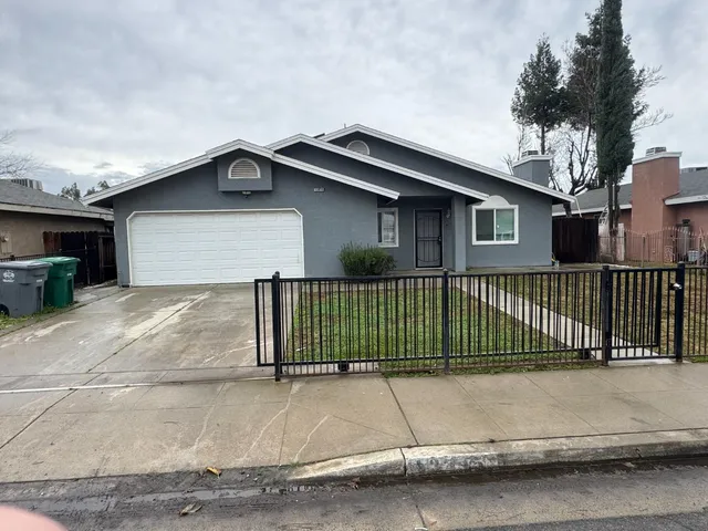 a view of a house with a wooden fence
