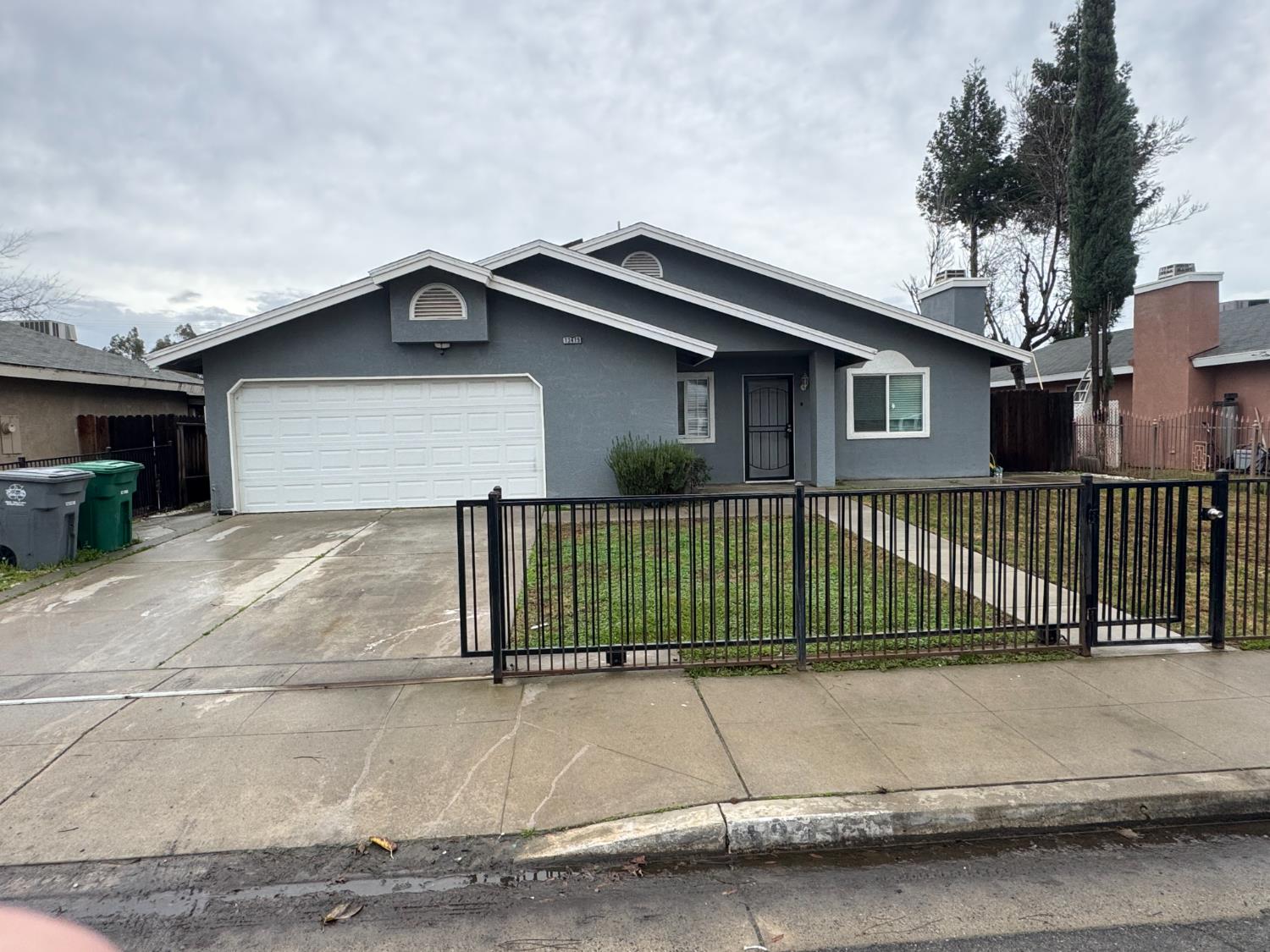 a view of a house with a wooden fence