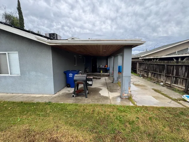 a view of a backyard with plants and a patio