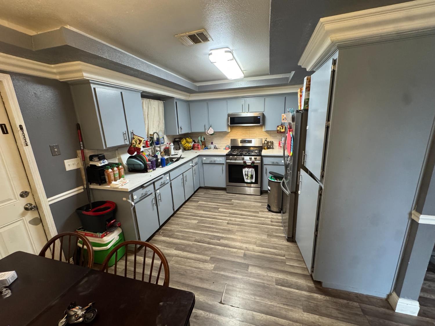 13415 South Vanderburgh Street Caruthers, CA 93609 - Photo 7 of 11 a kitchen with lots of appliances and wooden floor