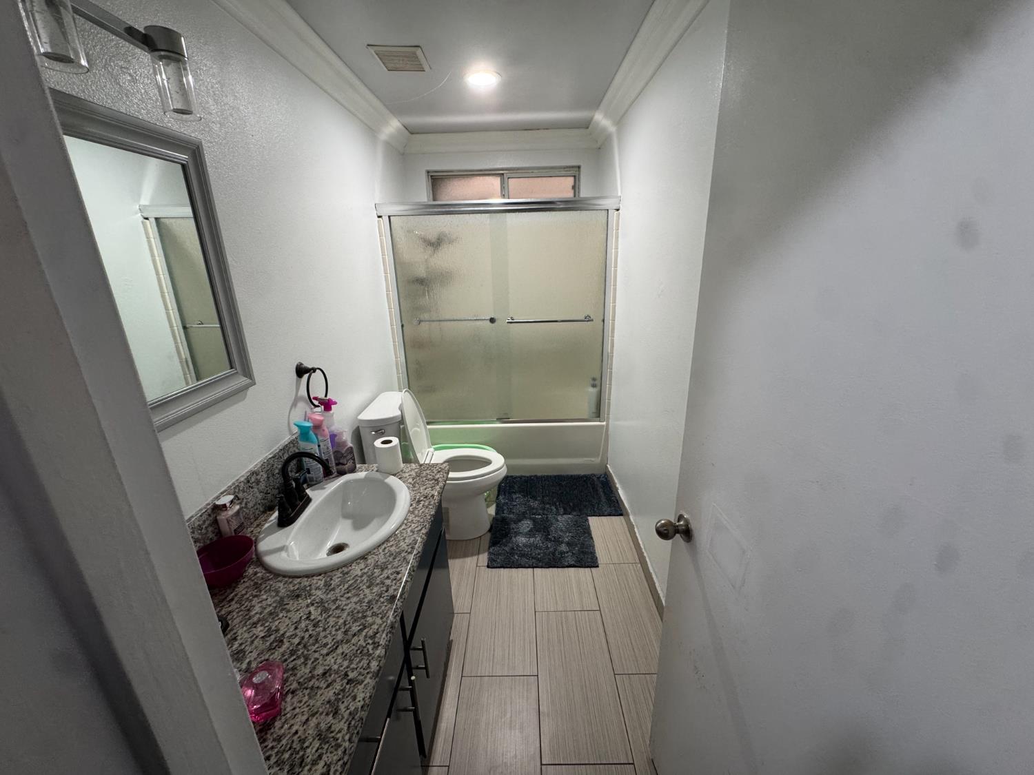 13415 South Vanderburgh Street Caruthers, CA 93609 - Photo 8 of 11 a bathroom with a granite countertop sink and a mirror
