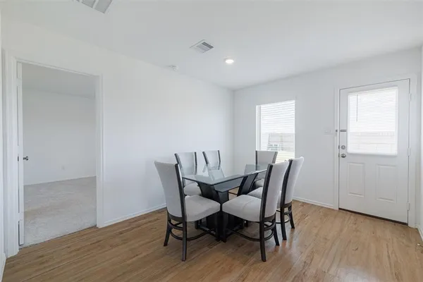 a view of a dining room with furniture and wooden floor