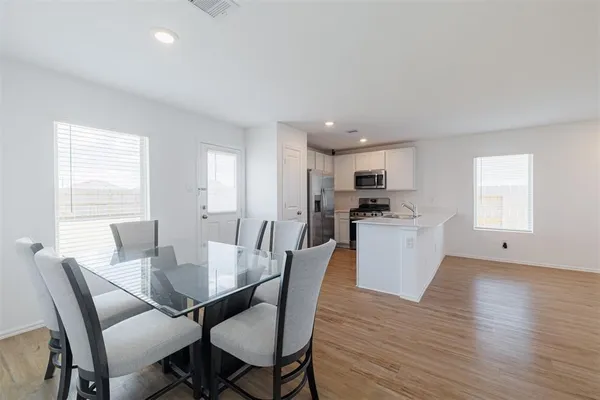 a view of a dining room with furniture and wooden floor