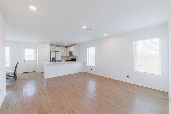 a view of a kitchen with wooden floor and a sink