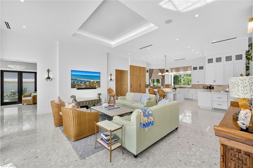 111 Caribbean Road Naples, FL 34108 - Photo 12 of 50 a living room with furniture kitchen view and a large window