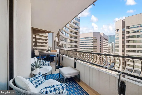 a balcony with furniture and a large window