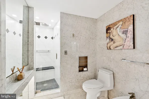 a bathroom with a toilet sink and shower