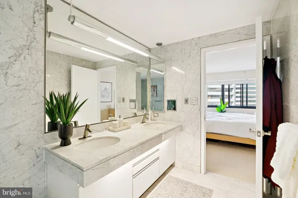 a en suite bathroom with a granite countertop sink and a mirror
