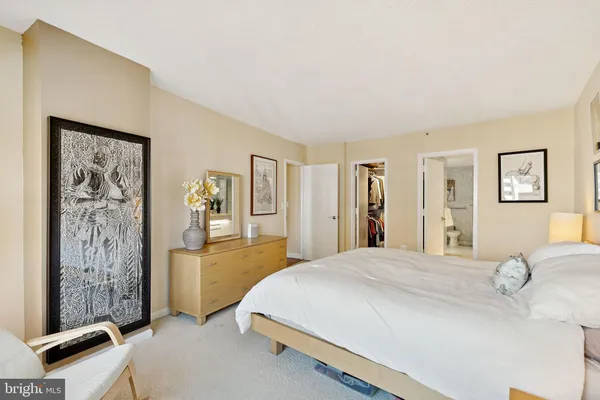 a bedroom with a bed and a mirror