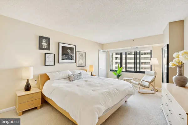 a bedroom with a bed and a couch