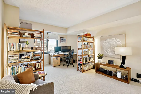 a living room with furniture gym equipment and a window