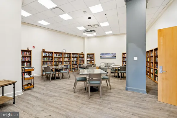 a living room with furniture and a book shelf