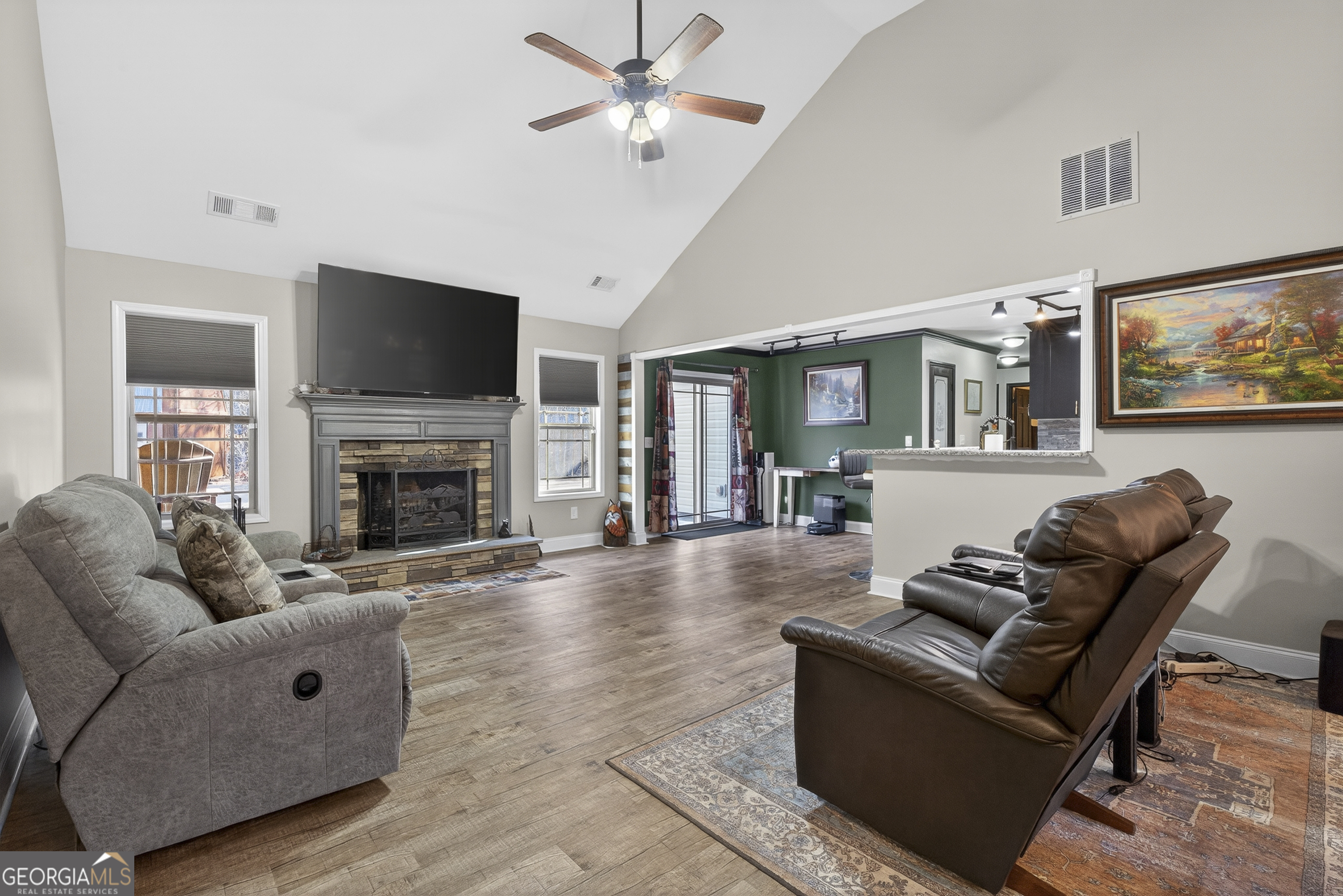 255 Needleleaf Drive Barnesville, GA 30204 - Photo 11 of 47 a living room with furniture a flat screen tv and a fireplace