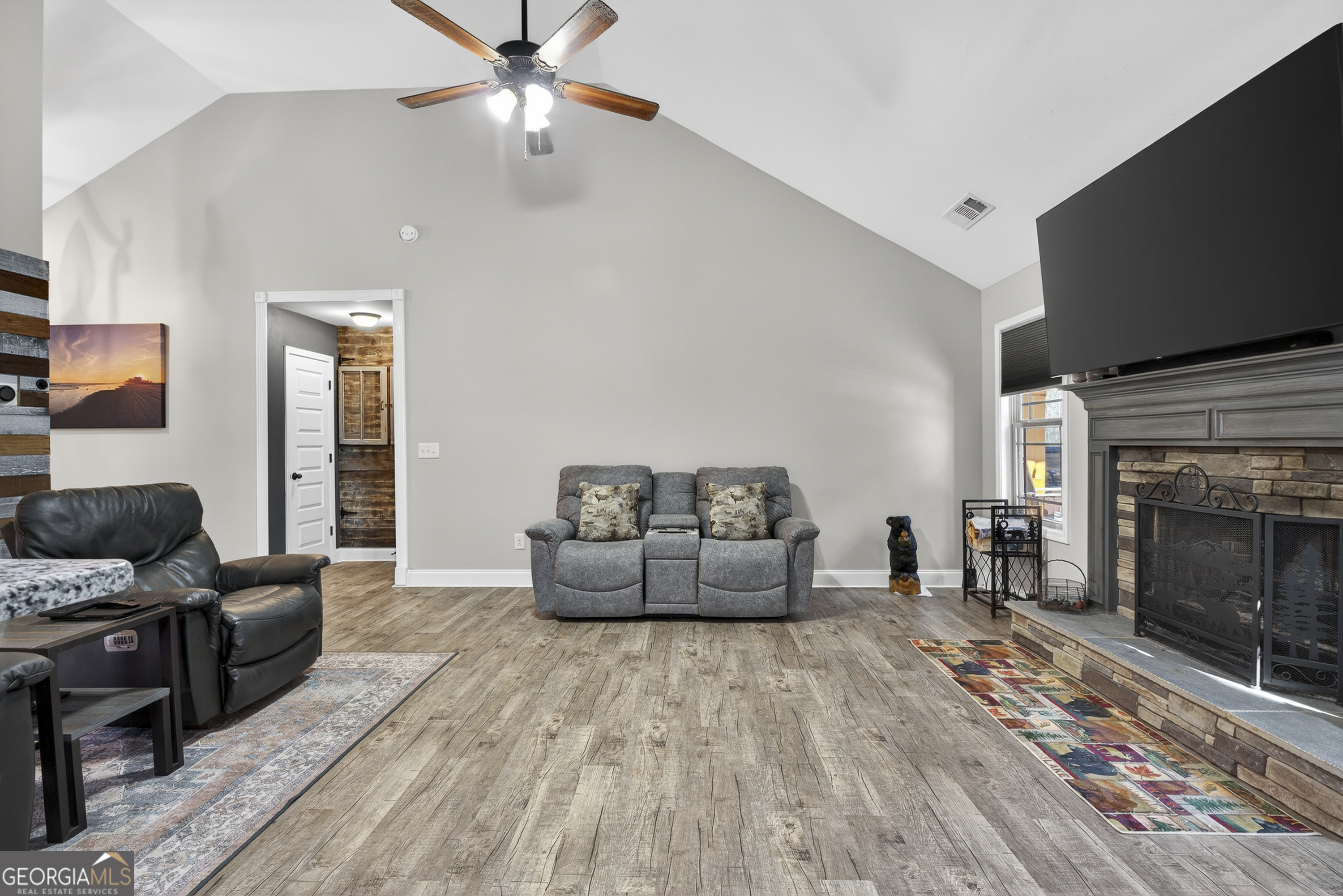 255 Needleleaf Drive Barnesville, GA 30204 - Photo 12 of 47 a living room with furniture and a fireplace