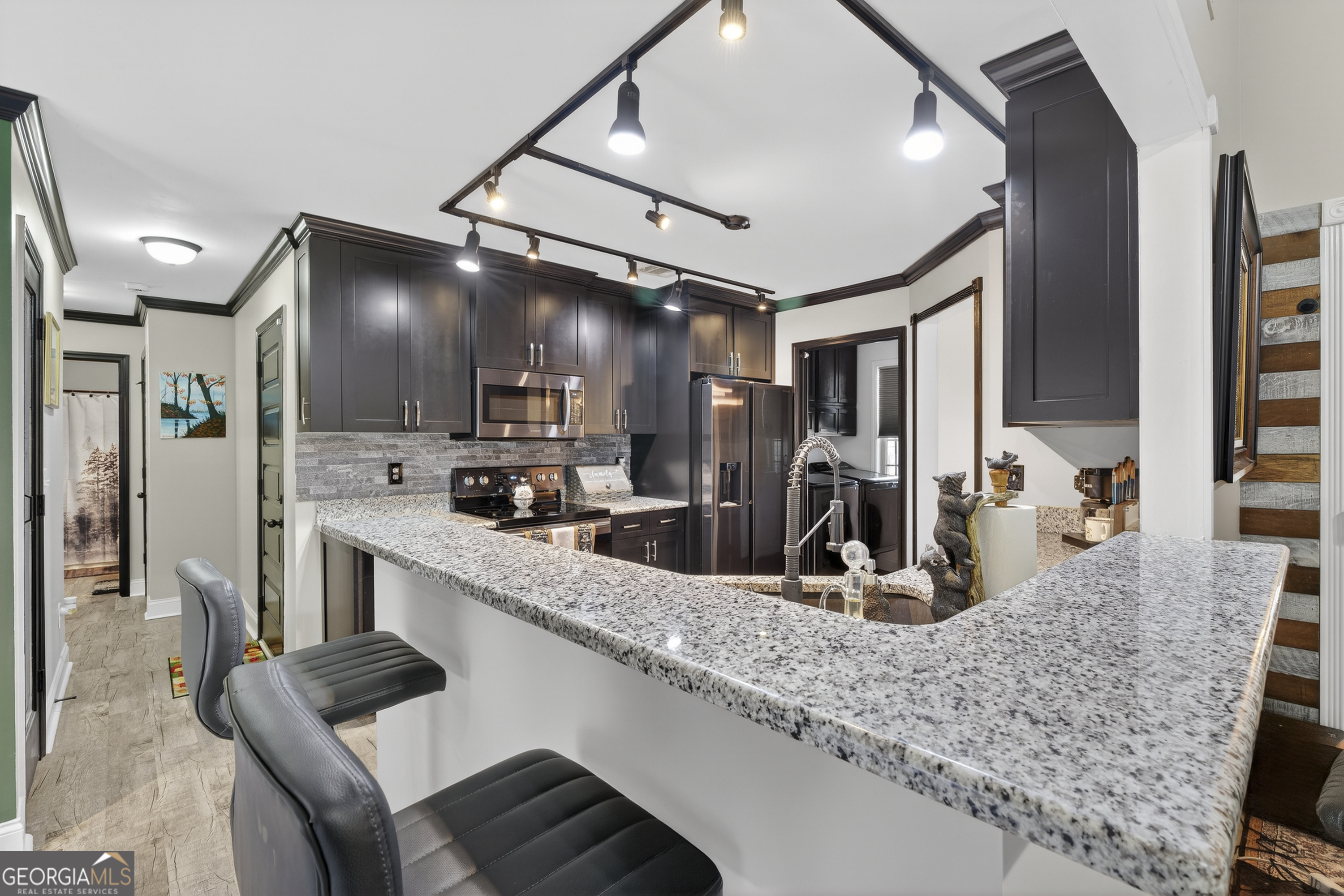 255 Needleleaf Drive Barnesville, GA 30204 - Photo 15 of 47 a kitchen with stainless steel appliances granite countertop a sink and a refrigerator