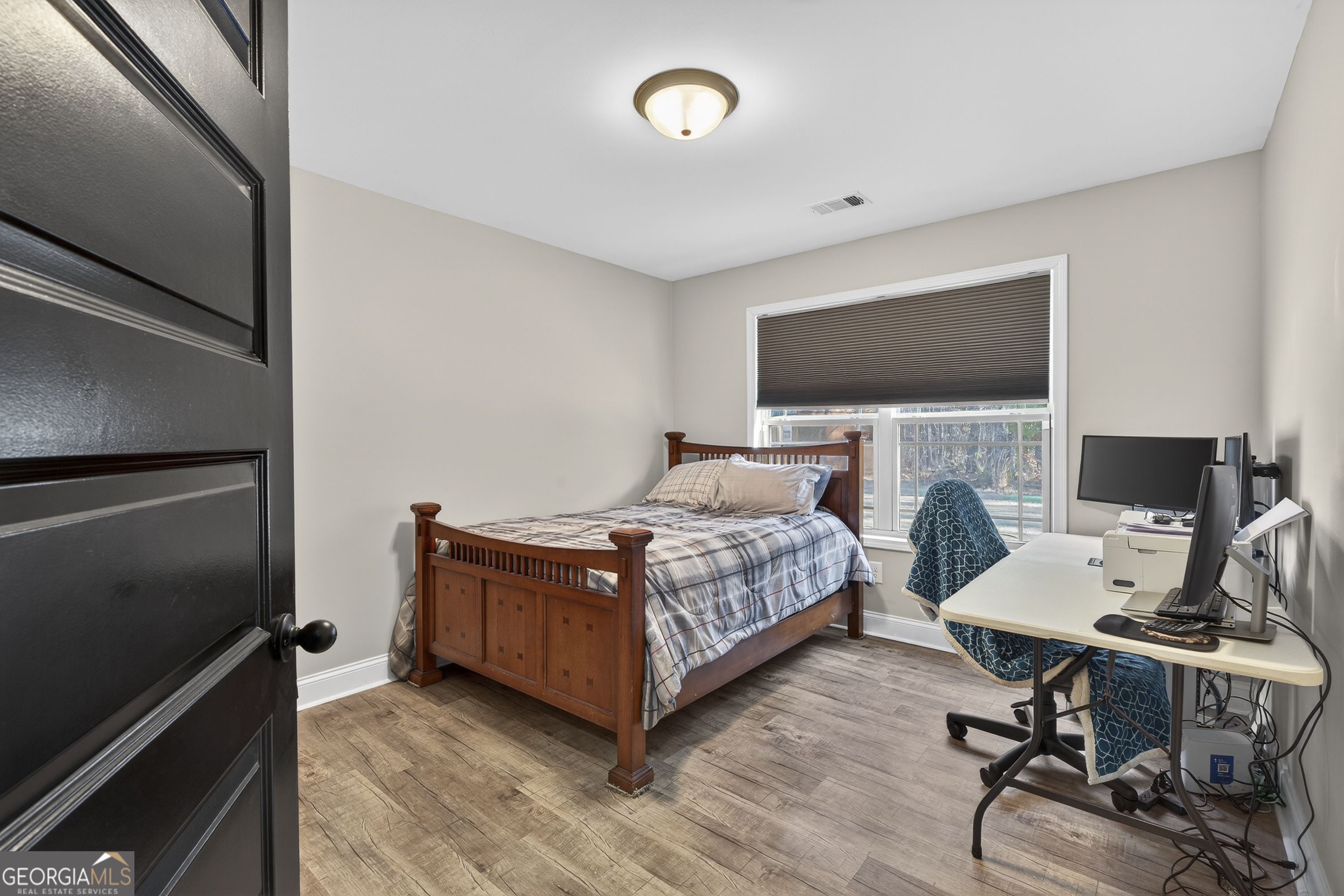 255 Needleleaf Drive Barnesville, GA 30204 - Photo 22 of 47 a bedroom with a bed and a flat screen tv