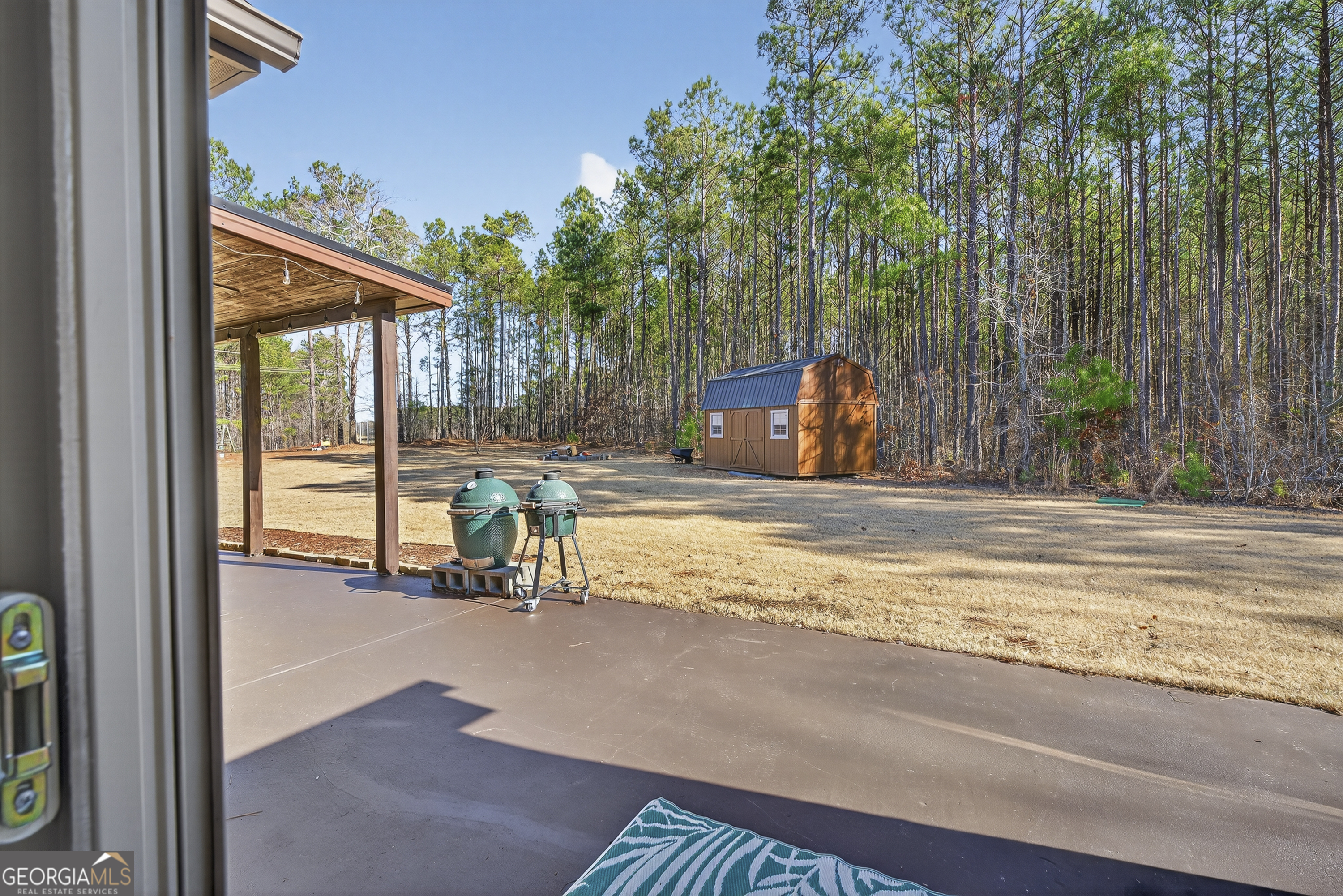 255 Needleleaf Drive Barnesville, GA 30204 - Photo 28 of 47 a view of swimming pool with lawn chairs and large trees