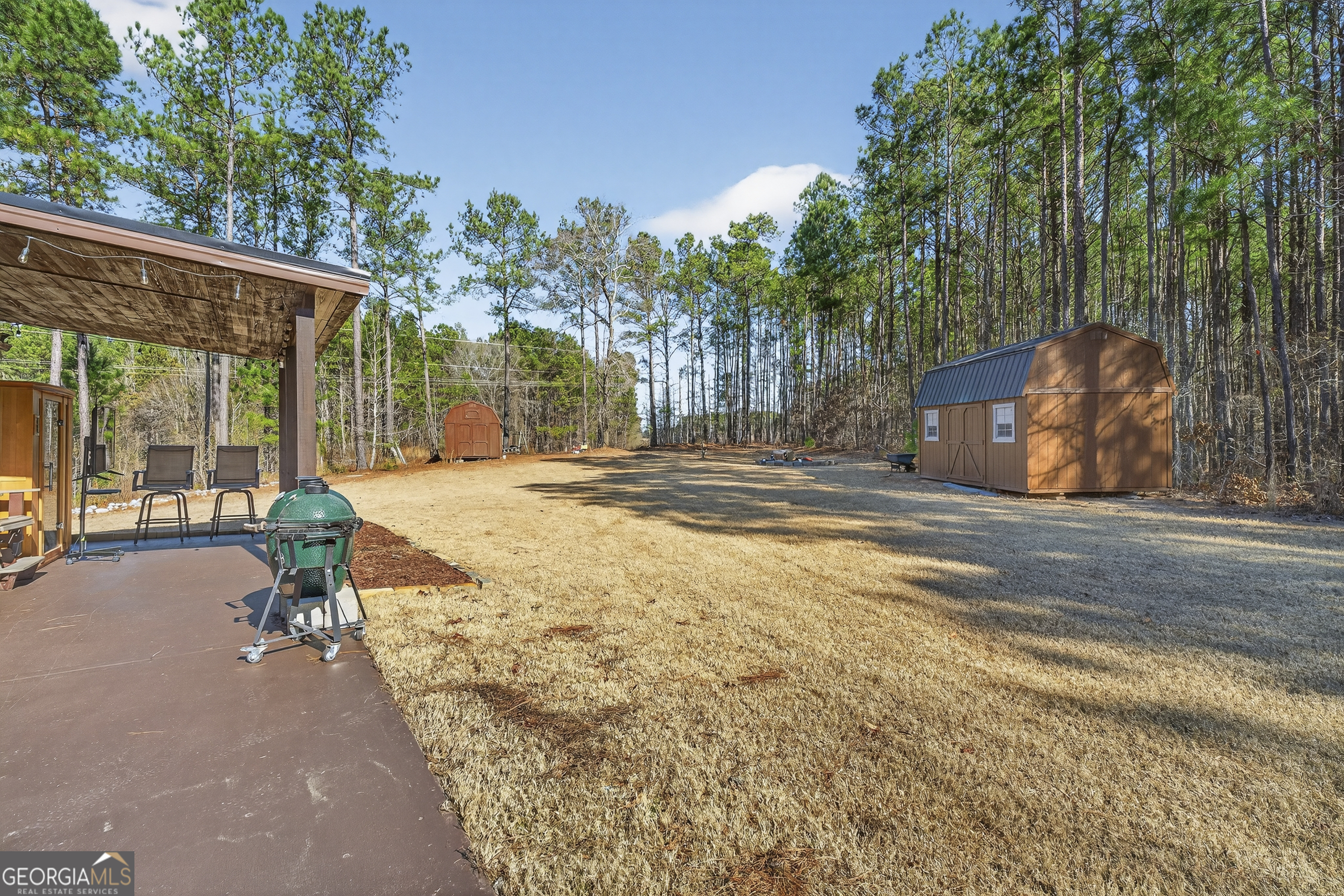 255 Needleleaf Drive Barnesville, GA 30204 - Photo 39 of 47 a swimming pool with outdoor seating and yard