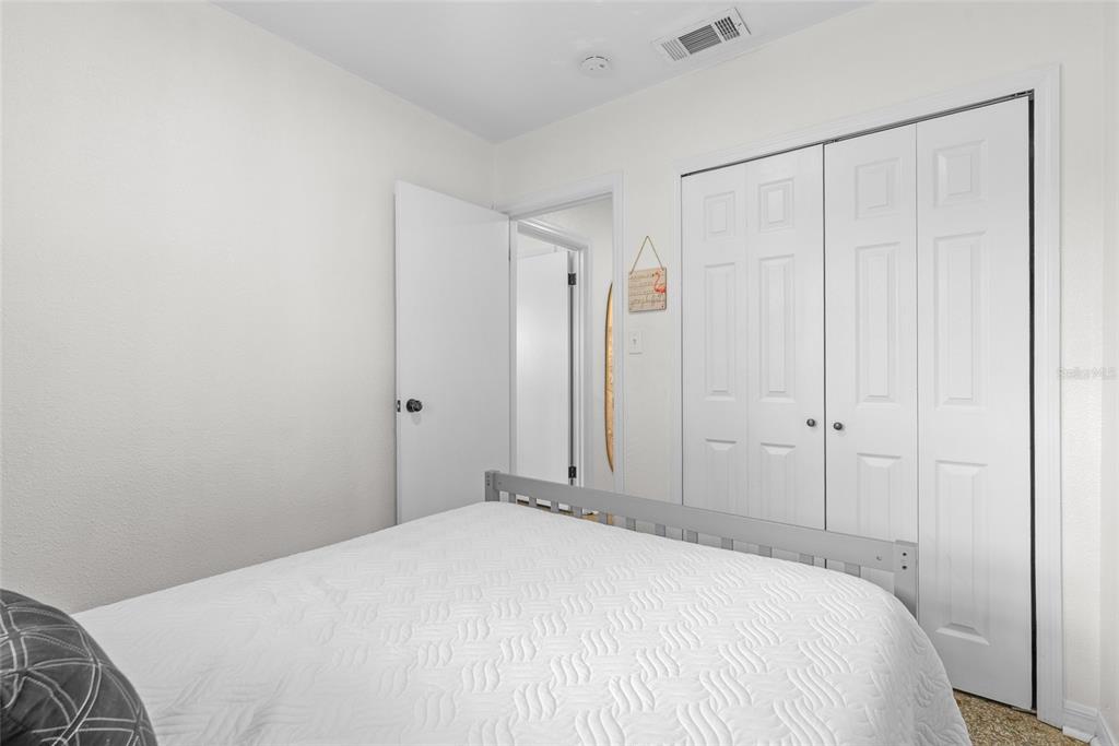 4939 100th Way North St. Petersburg, FL 33708 - Photo 25 of 43 a bedroom with a bed and a cabinet