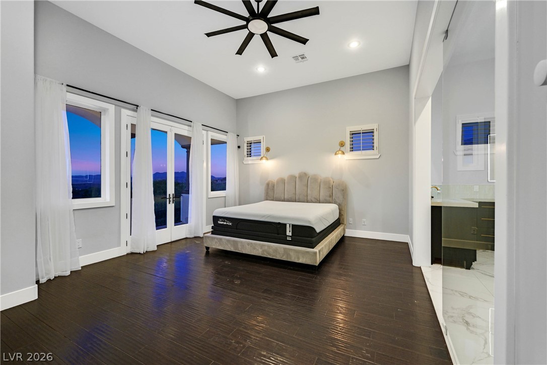 6 Rue Du Ville Henderson, NV 89011 - Photo 56 of 99 This spacious bedroom offers serene views and a seamless transition to the primary bath.