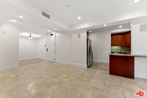 an empty room with furniture and a fireplace