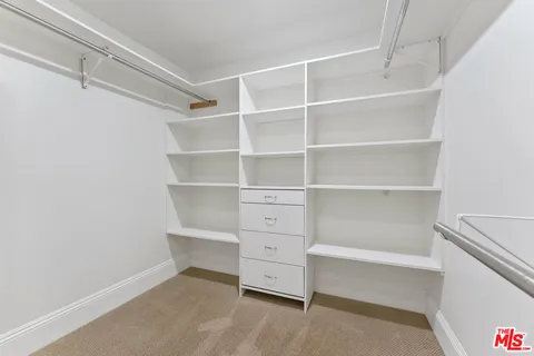 an empty room with windows and fireplace