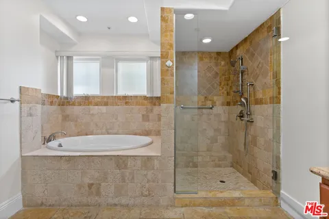 a bathroom with a granite countertop sink mirror and shower