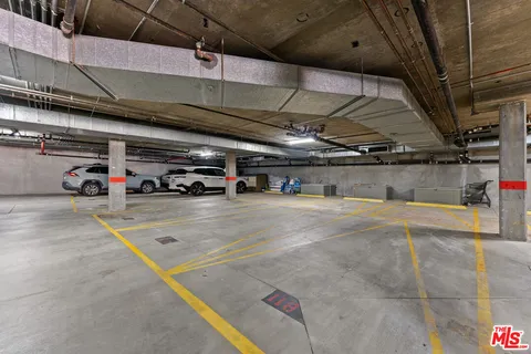 a view of parking garage with cars