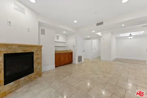 a view of an empty room with a fireplace