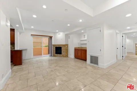 a view of an empty room with a kitchen