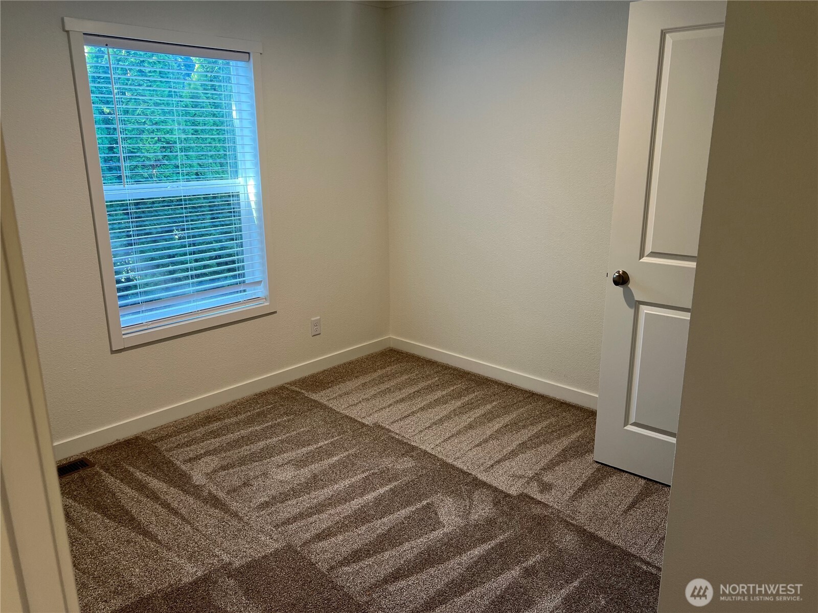 512 Southwest Berry Lake Road, Unit 21 Port Orchard, WA 98367 - Photo 13 of 19 a view of a room with a wooden floor and window