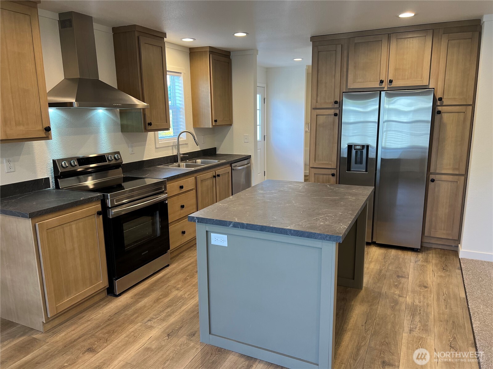 512 Southwest Berry Lake Road, Unit 21 Port Orchard, WA 98367 - Photo 2 of 19 a kitchen with stainless steel appliances granite countertop a stove a refrigerator and a sink