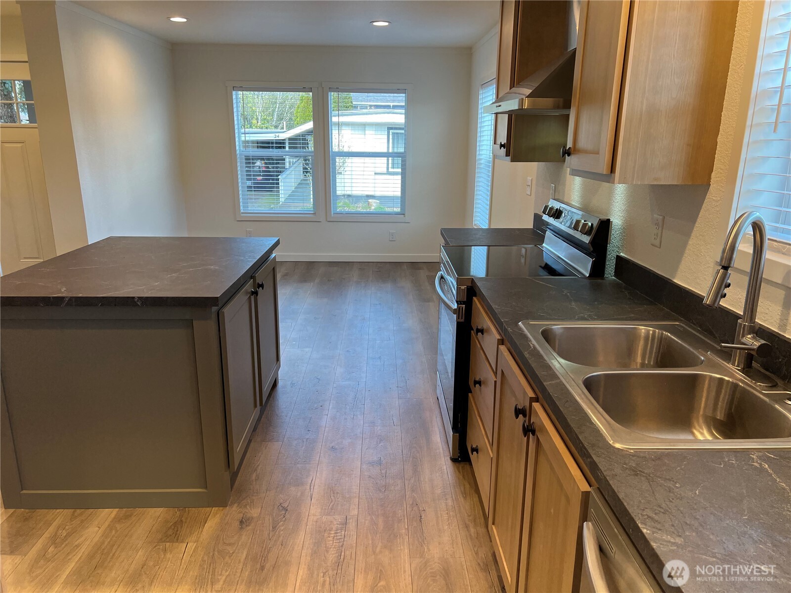 512 Southwest Berry Lake Road, Unit 21 Port Orchard, WA 98367 - Photo 4 of 19 a kitchen with a sink stove and cabinets