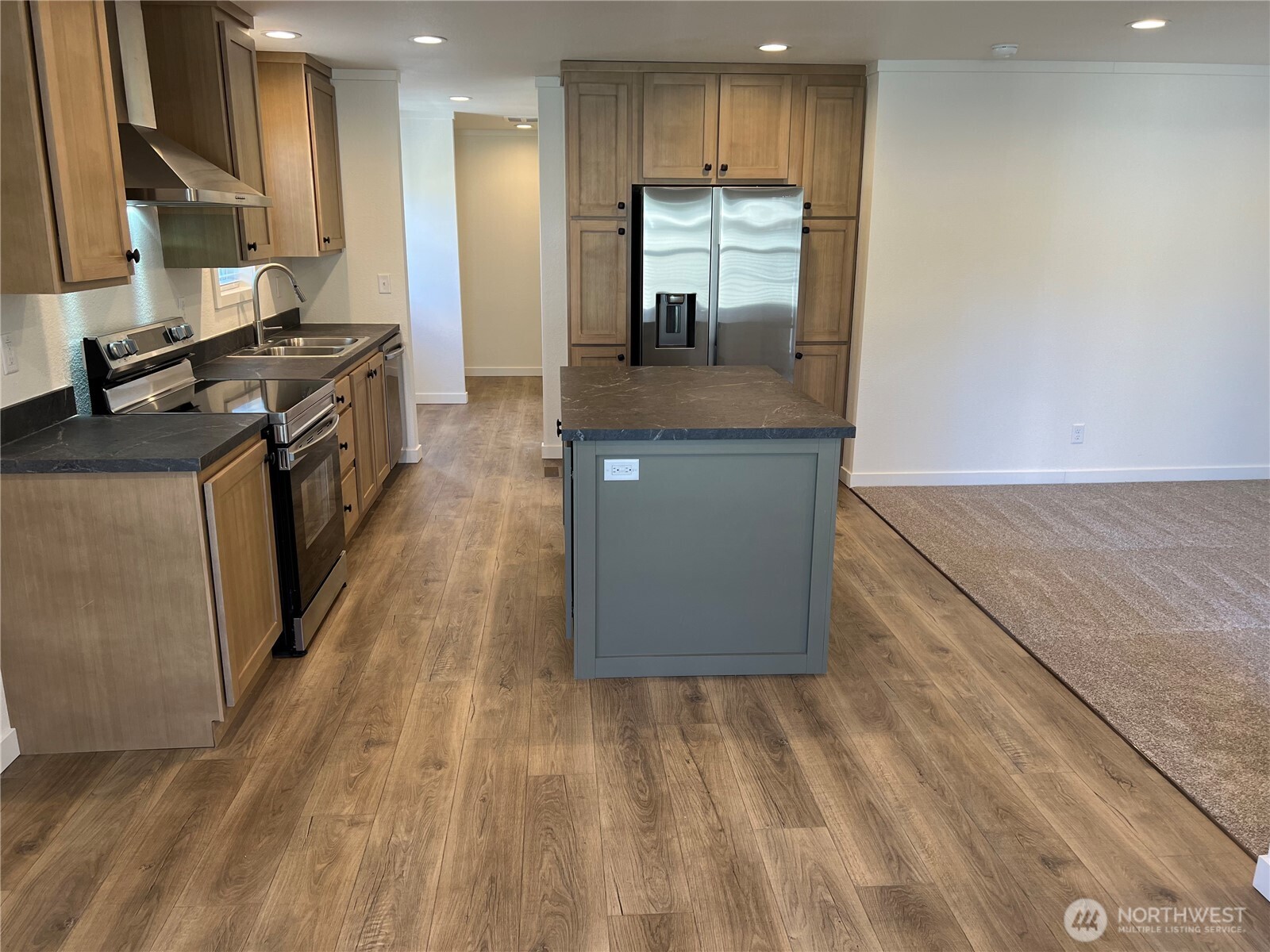 512 Southwest Berry Lake Road, Unit 21 Port Orchard, WA 98367 - Photo 6 of 19 a kitchen with stainless steel appliances granite countertop a stove a sink and a refrigerator