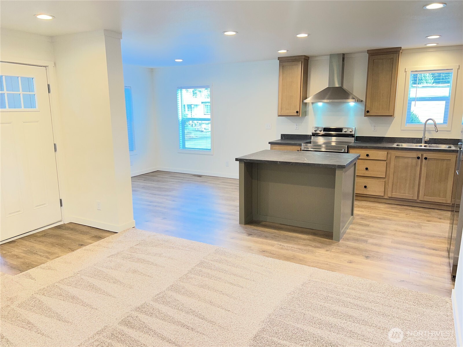512 Southwest Berry Lake Road, Unit 21 Port Orchard, WA 98367 - Photo 8 of 19 a view of kitchen with granite countertop cabinets and stove