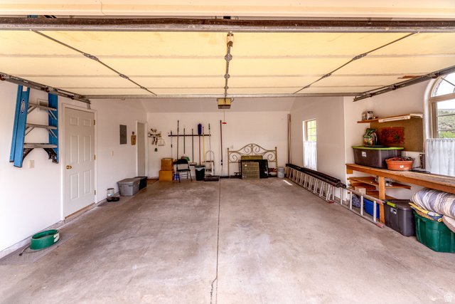 7343 North Sawtooth Cv Road Vernal, UT 84078 - Photo 52 of 64 Spacious garage featuring a concrete floor, white interior walls, and a work bench